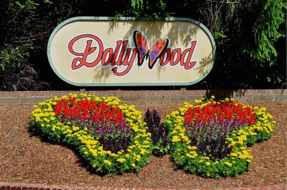 The Dollywood sign and butterfly flower arrangement at the theme park's entrance.