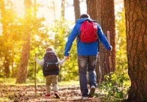 Father and son hiking in the woods