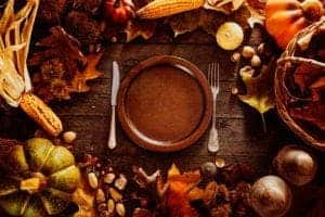 A dinner plate surrounded by autumn decorations.