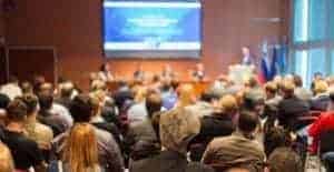 Audience listening to a speech at a convention.