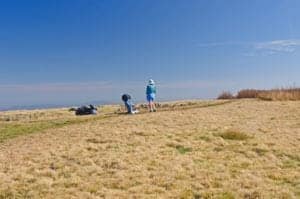 A hiker at the top of Gregory Bald.