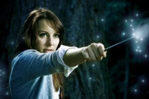 A young woman casting a spell with her magic wand.