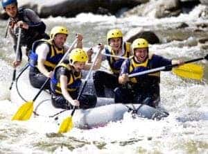 A group of people enjoying white water rafting.