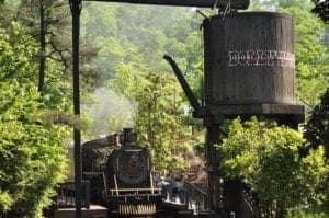 A train pulling into the station at the Dollywood theme park.