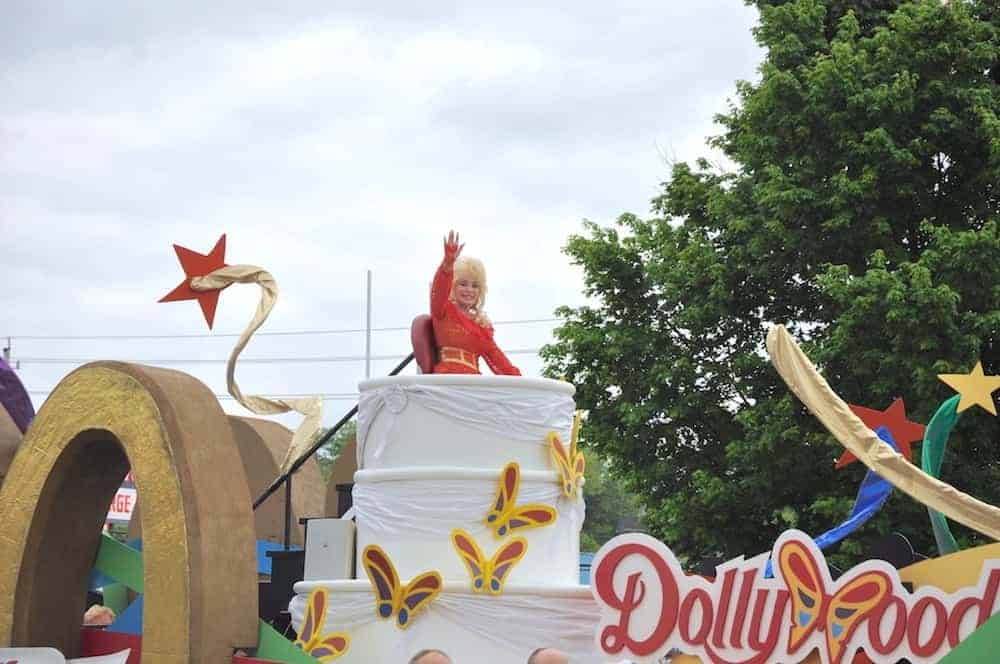 Dolly Parton waving from a float in her parade in Pigeon Forge.