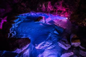 A cave bathed in purple light.