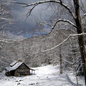 A log cabin covered in snow in the Smoky Mountains.