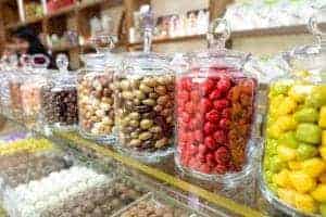 Brightly colored candies in jars in a candy shop.