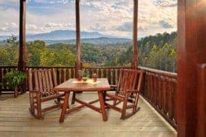 Chairs sitting on the deck of a cabin rental in Pigeon Forge with mountain views.