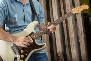 A man with an electric guitar.