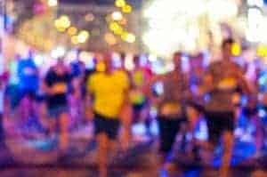 A group of people running a race at night.