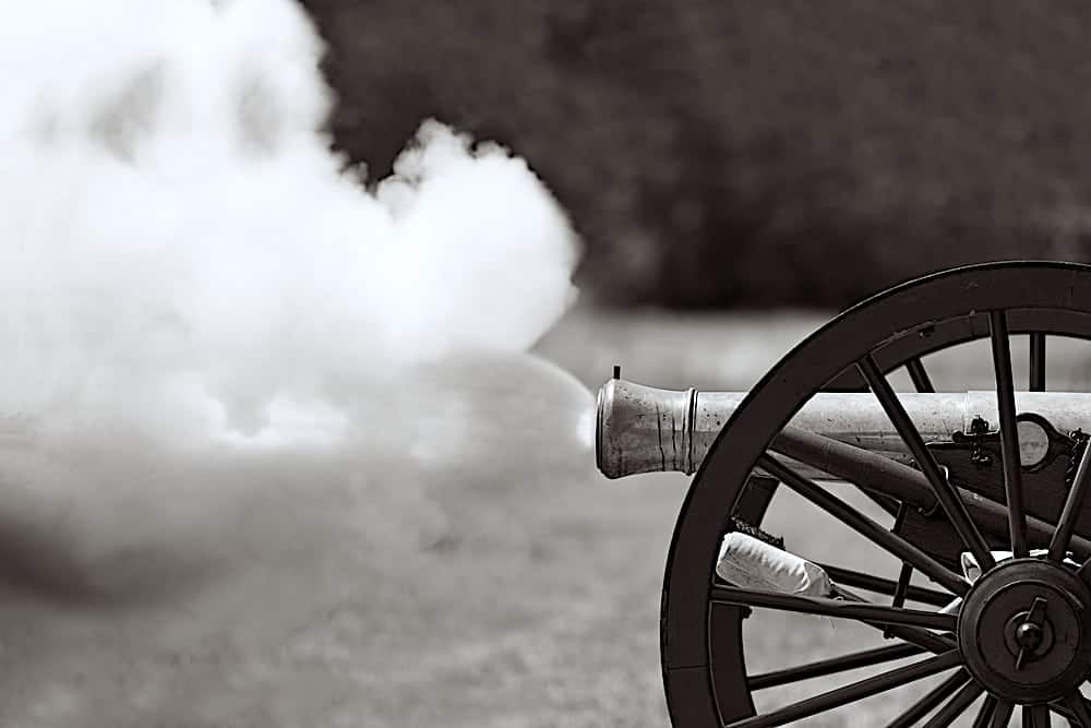 A cannon firing during a reenactment of a Civil War battle.