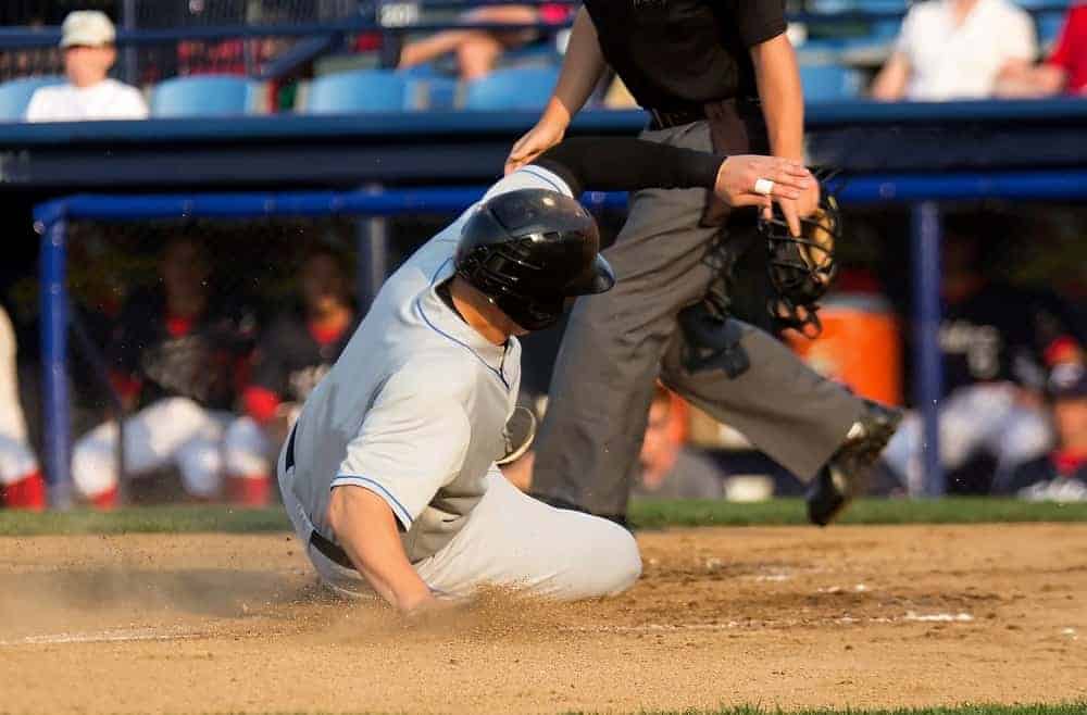 Baseball player sliding onto a base.