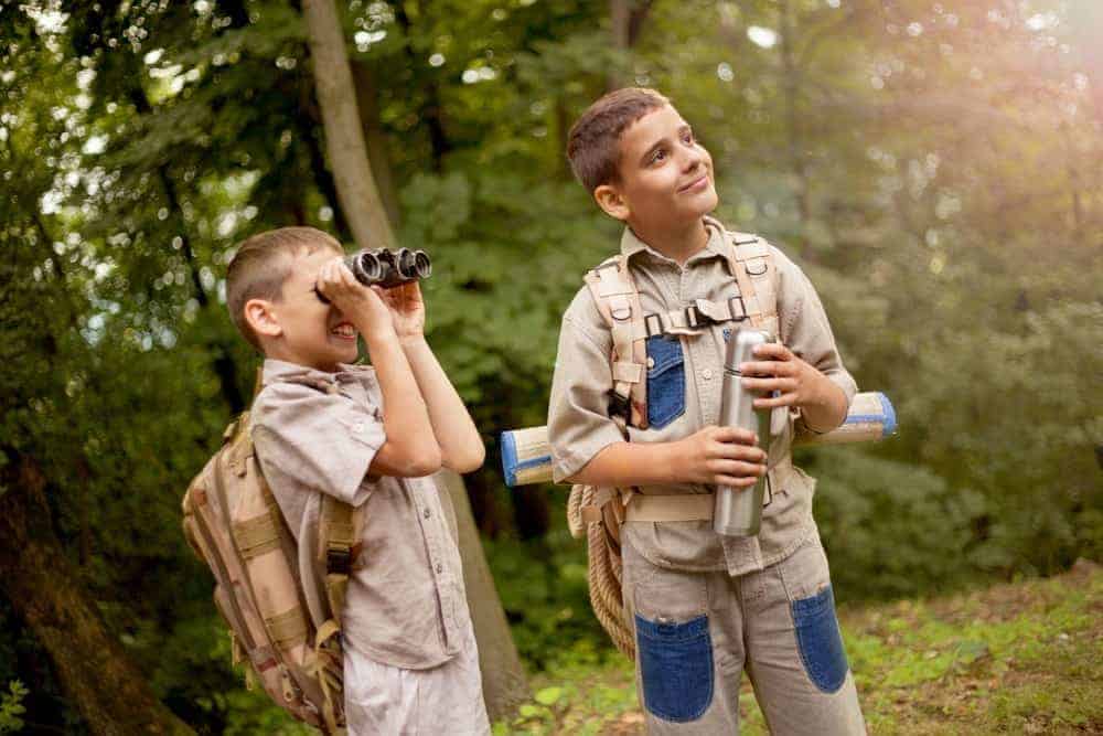 Boys dressed like Junior Rangers in the forest.