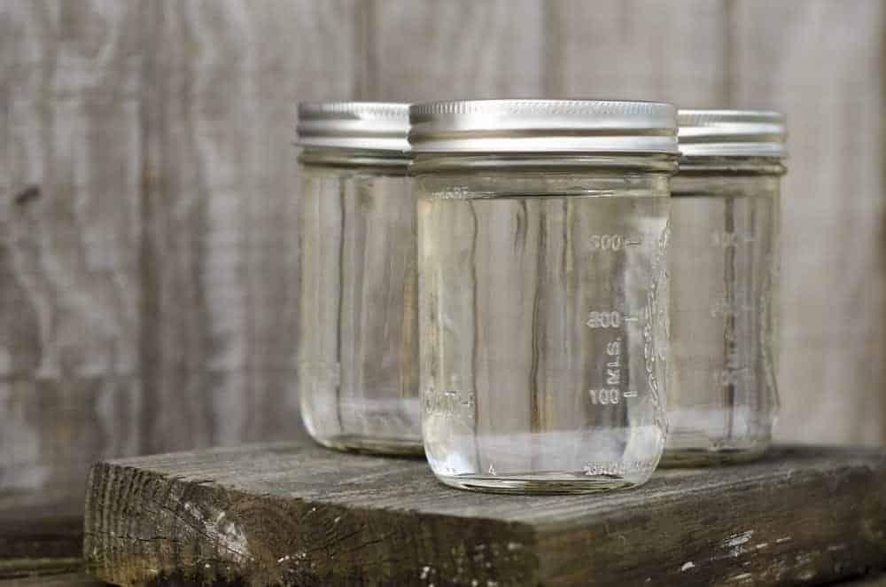 Mason jars filled with moonshine.