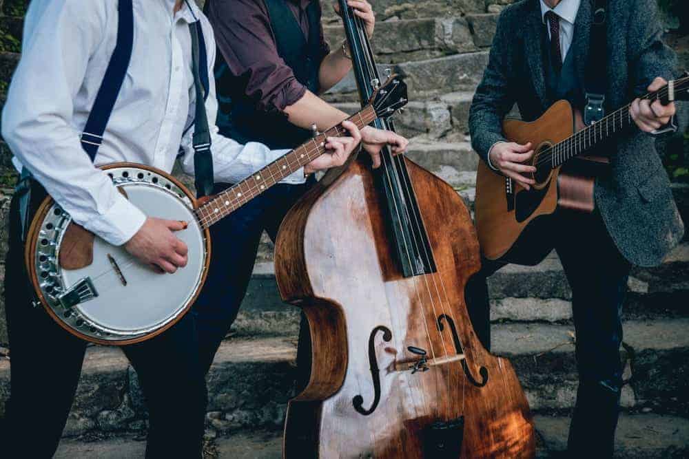 A bluegrass band posing with their instruments.