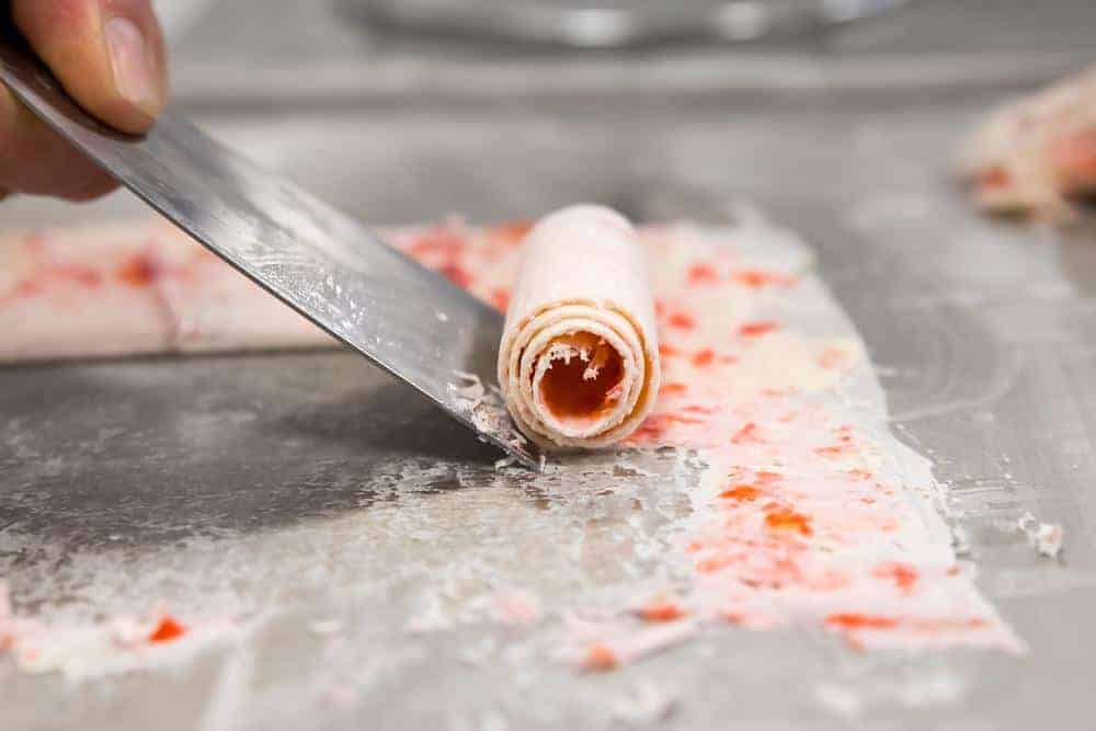 Delicious rolled ice cream being prepared.