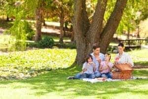 Happy family enjoying a picnic in a park.
