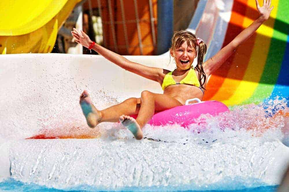 A girl enjoying a water slide.
