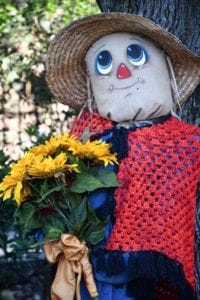 A scarecrow holding flowers at Dollywood.