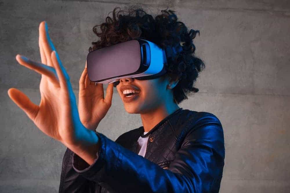 A woman using a virtual reality headset.