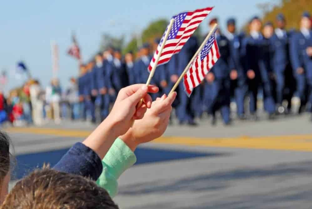 American flags waving at a veterans parade.