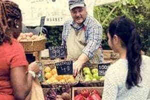 Friends shopping at a farmers market.