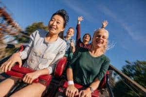 Friends riding a roller coaster.