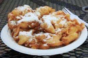 Funnel cake covered in powdered sugar.