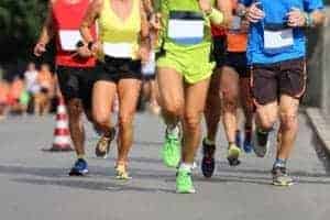 Women and men running a race.