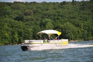 A pontoon boat on a lake.