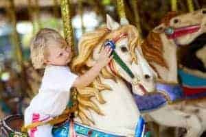 girl riding carousel at dollywood