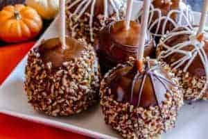 caramel apples on plate with pumpkins