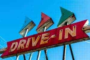A sign for a drive-in movie theater.