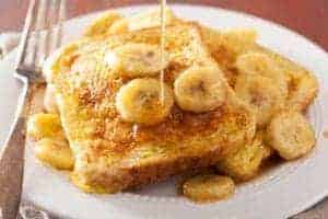 french toast with bananas and syrup