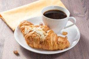 croissant and coffee on plate