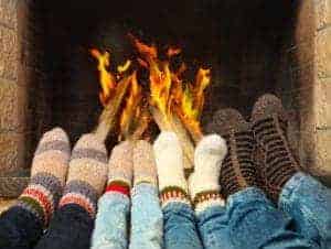 family relaxing in front of the fire