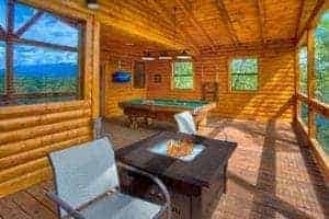 fire pit and pool table on deck of cabin in gatlinburg