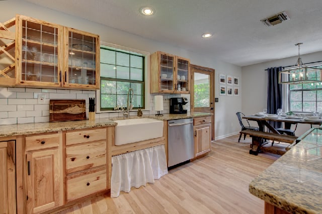 Open kitchen with granite countertops and farmhouse sink