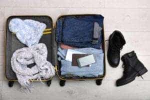 suitcase filled with winter clothes
