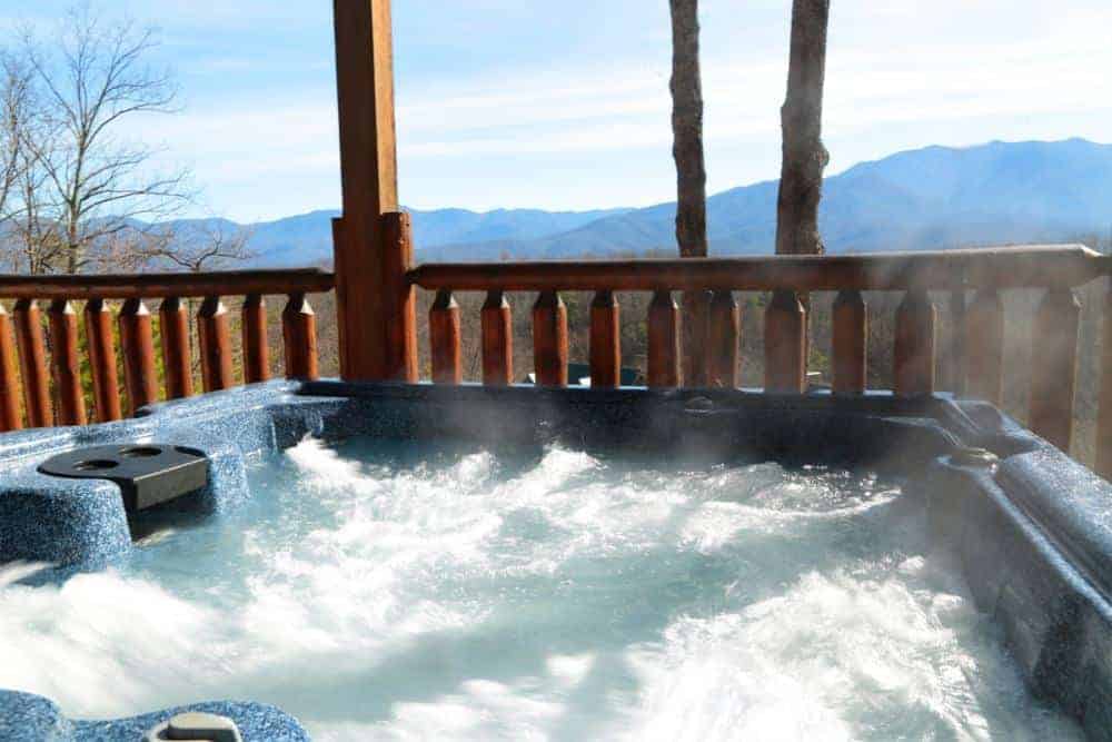 hot tub on the deck of a gatlinburg cabin in the winter