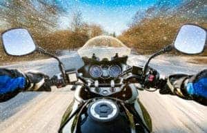 motorcycle riding on snowy road