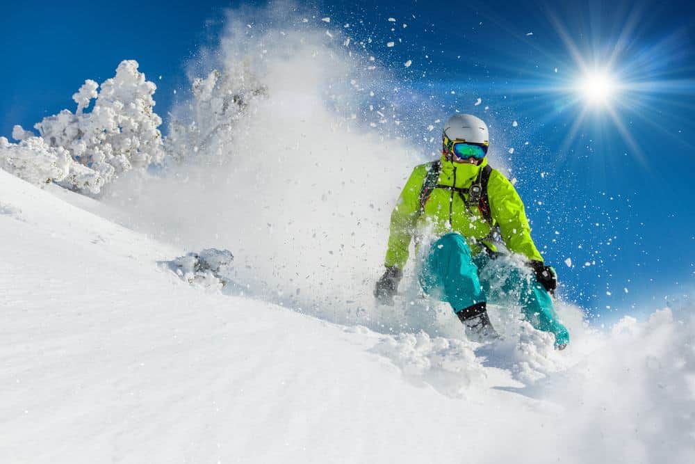 man skiing on slopes in mountains