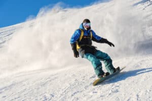 person snowboarding down a mountain