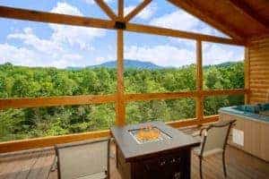 private deck of cabin with a fire pit