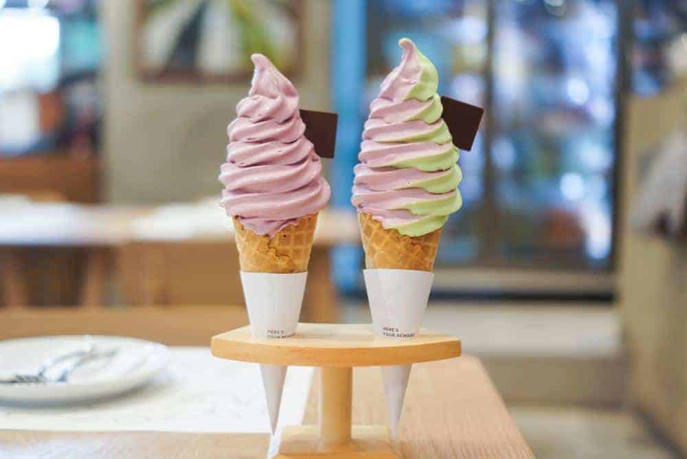 two soft serve ice cream cones in shop