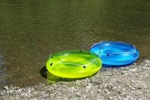 two tubes sitting on river bank