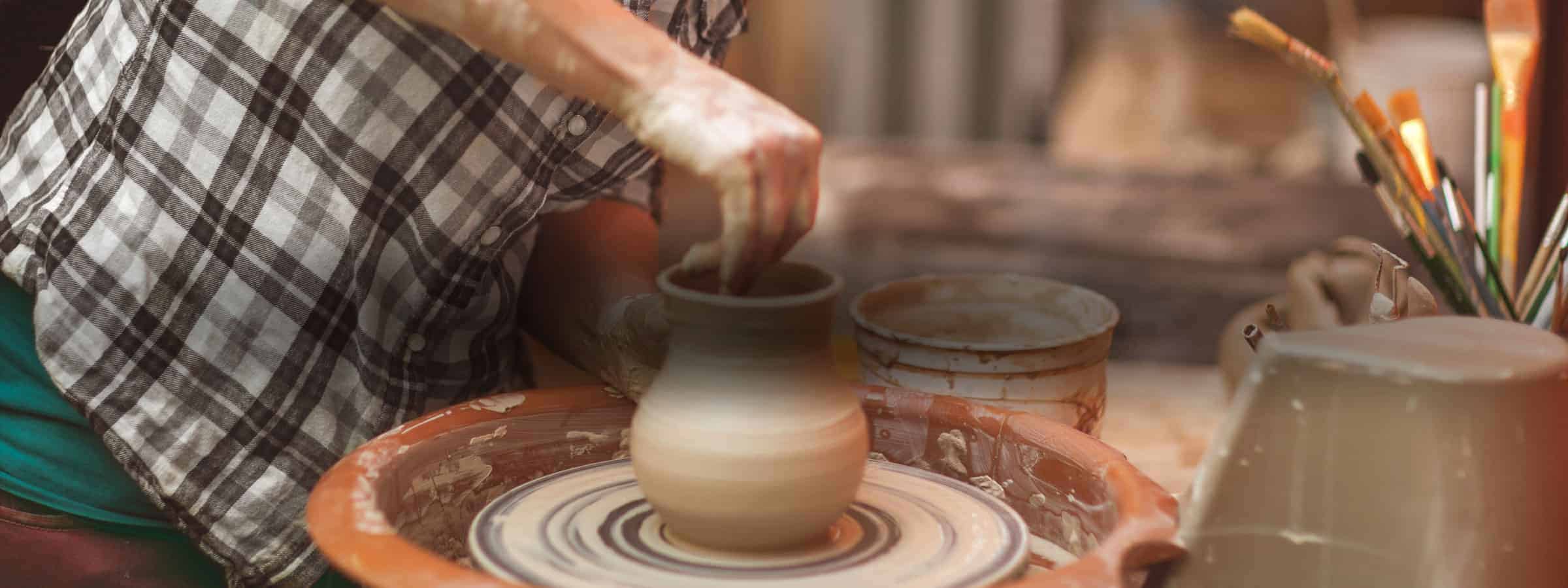 person making pottery