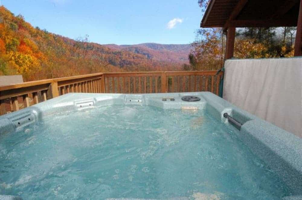 hot tub on the deck of a gatlinburg cabin in the fall