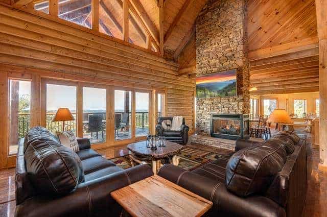 living room with stone fireplace